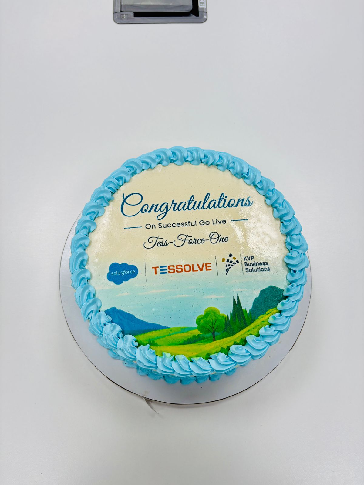 Tess-Force-One go-live celebration cake featuring Salesforce, Tessolve and KVP Business Solutions logos